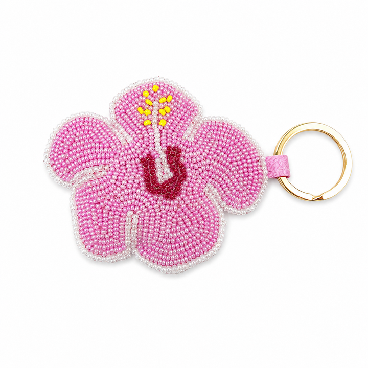 Pink beaded hibiscus flower keychain with yellow stamen detail and a gold split ring