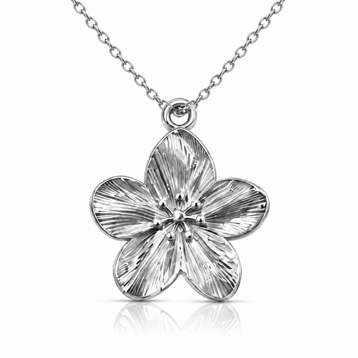 Textured five-petal hibiscus pendant in a polished silver finish on a fine cable chain