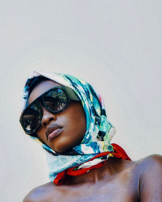 Printed mulberry silk scarf tied as a headscarf and worn with oversized sunglasses