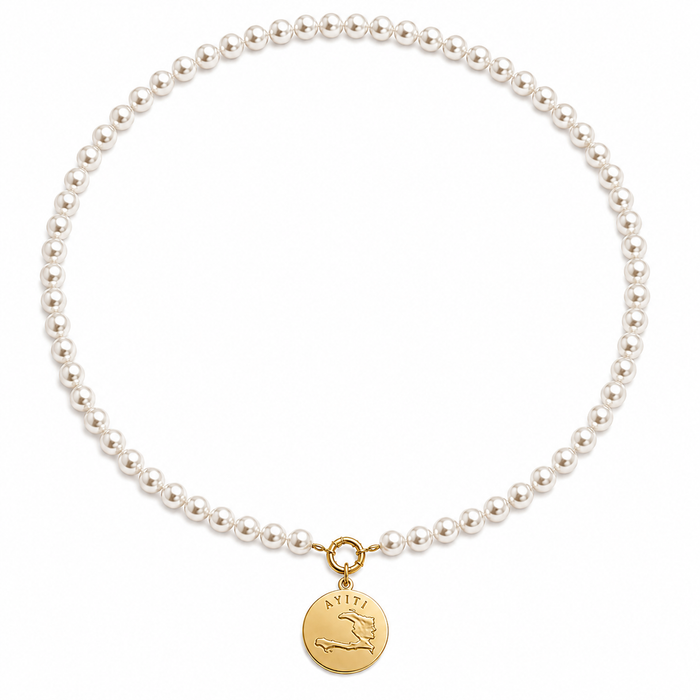 White freshwater pearl choker laid flat with a gold Ayiti coin pendant on a ring clasp