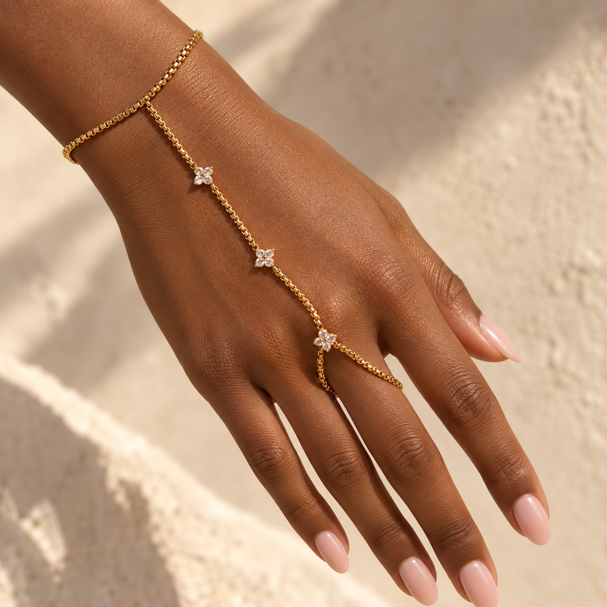 Hand chain worn across the back of the hand, blossoms catching sunlight