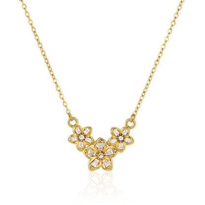 Three crystal-set flowers clustered on a fine gold chain, laid flat on white