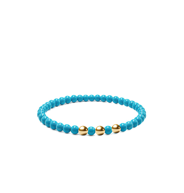 Turquoise bead bracelet with three 4mm gold beads, laid flat on white