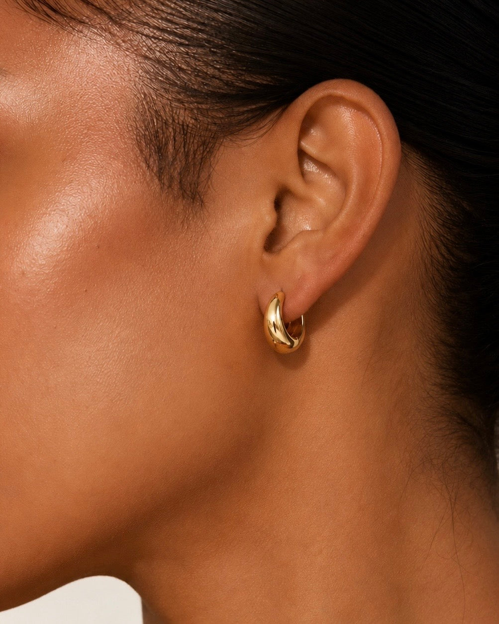 Close-up of a polished gold hoop earring